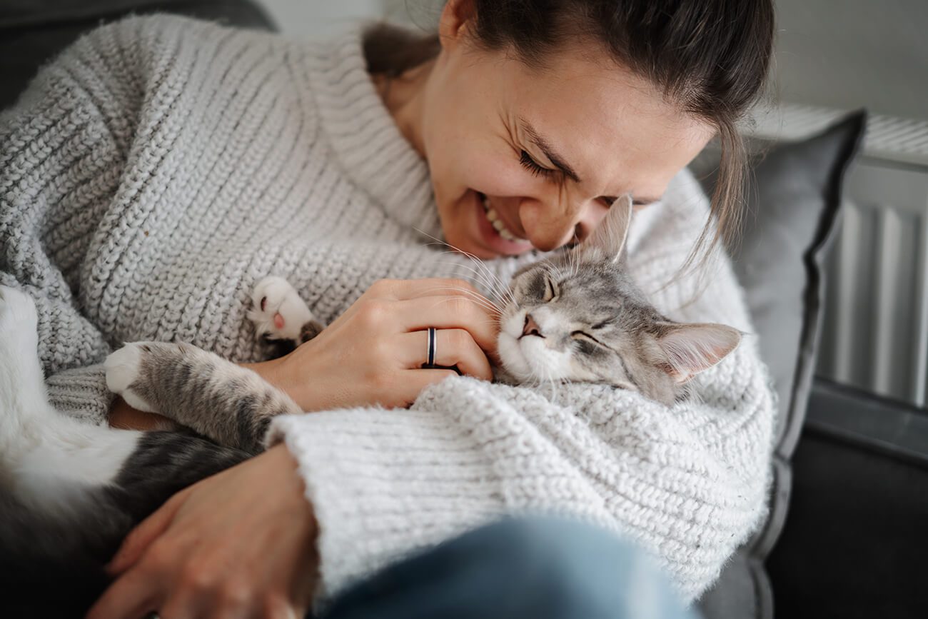 Woman In Sweater Holding Cat